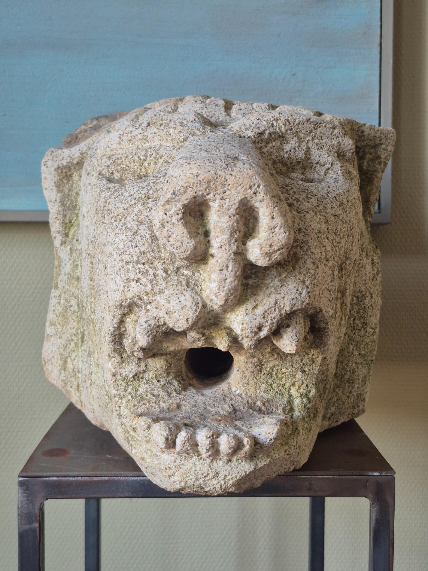 Antique stone gargoyle fragment